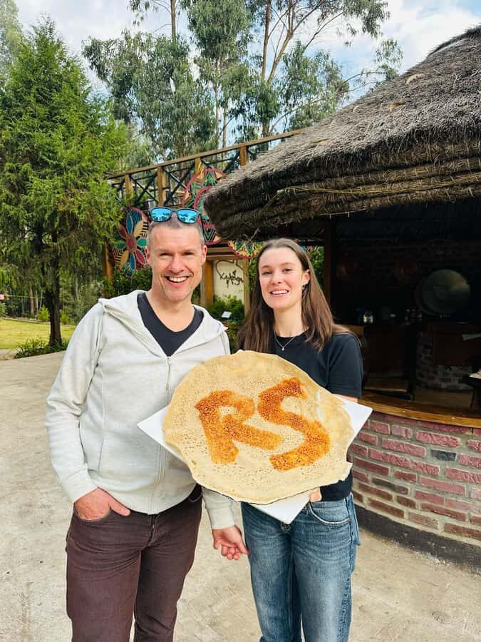 Ethiopia coffee cupping class/Ethiopian food injera making - Injera making on the mitad: the part where you roll up your sleeves